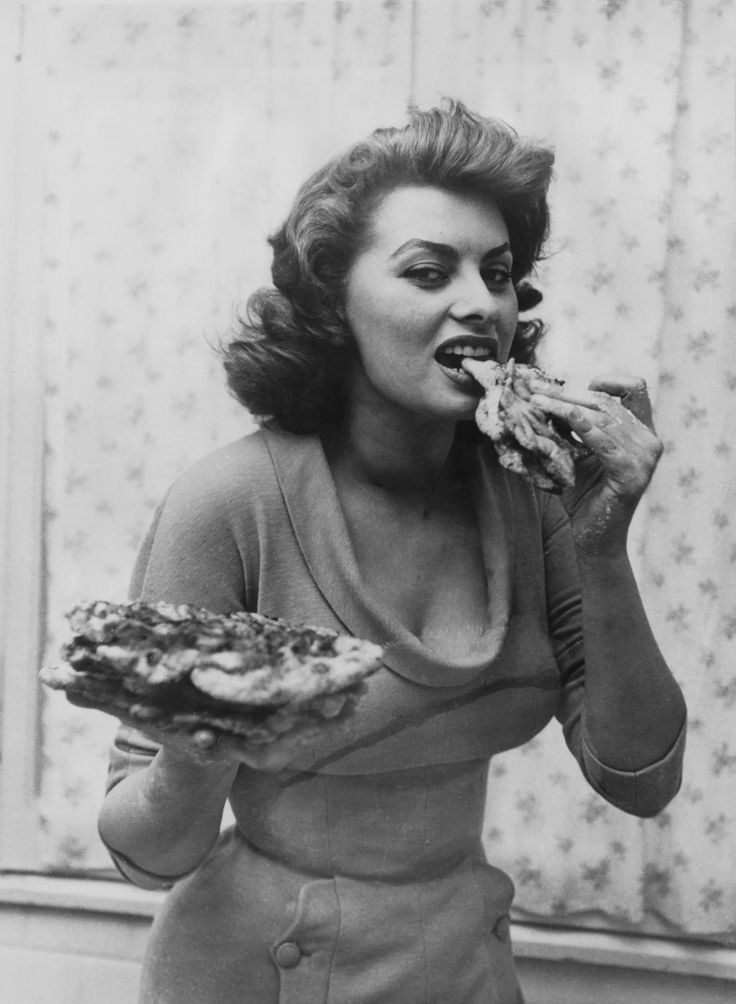 Vintage photo of woman eating pizza